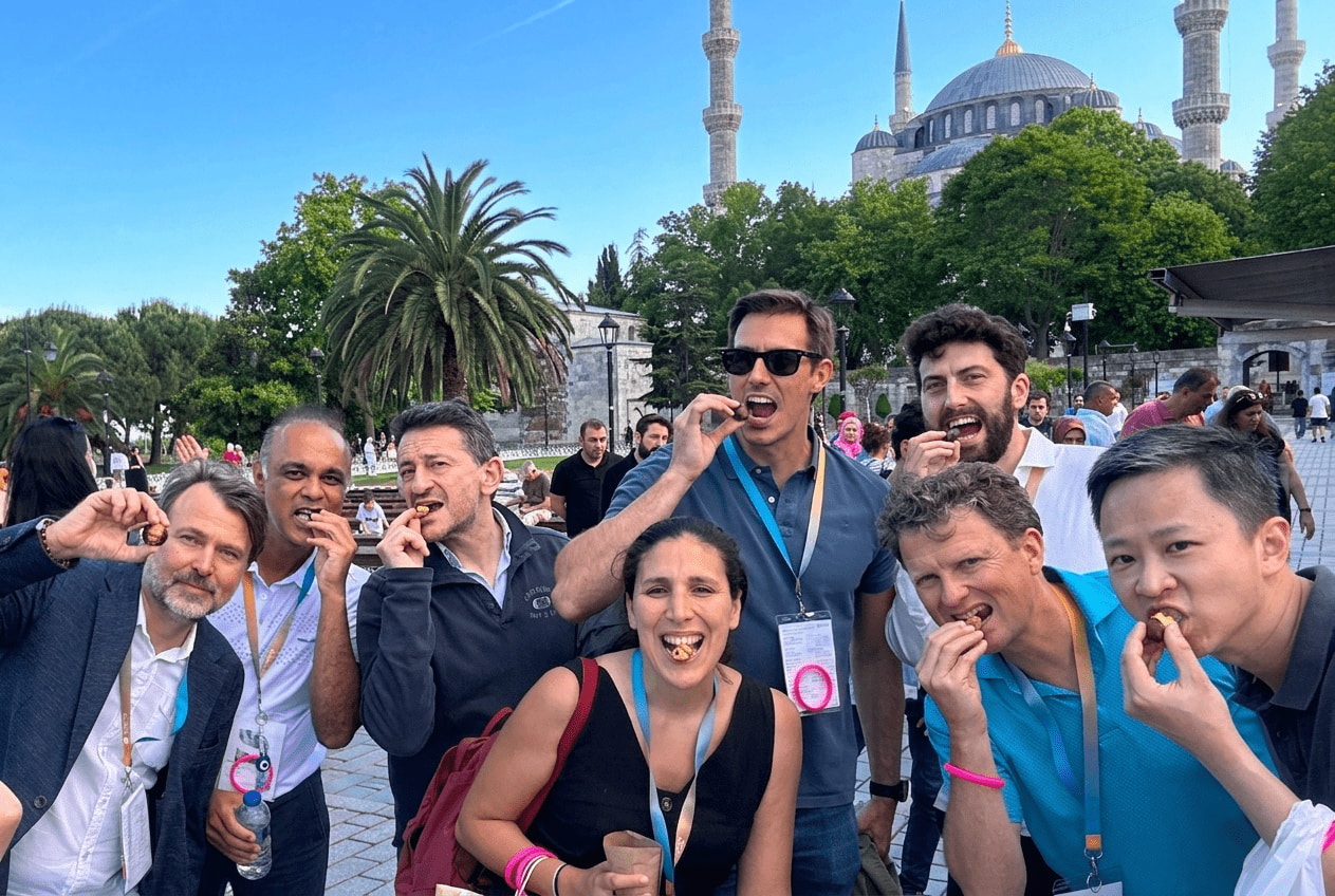 Corporate group enjoying roasted chestnuts during a team building activity in Sultanahmet, Istanbul